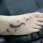 Feathers foot tattoo